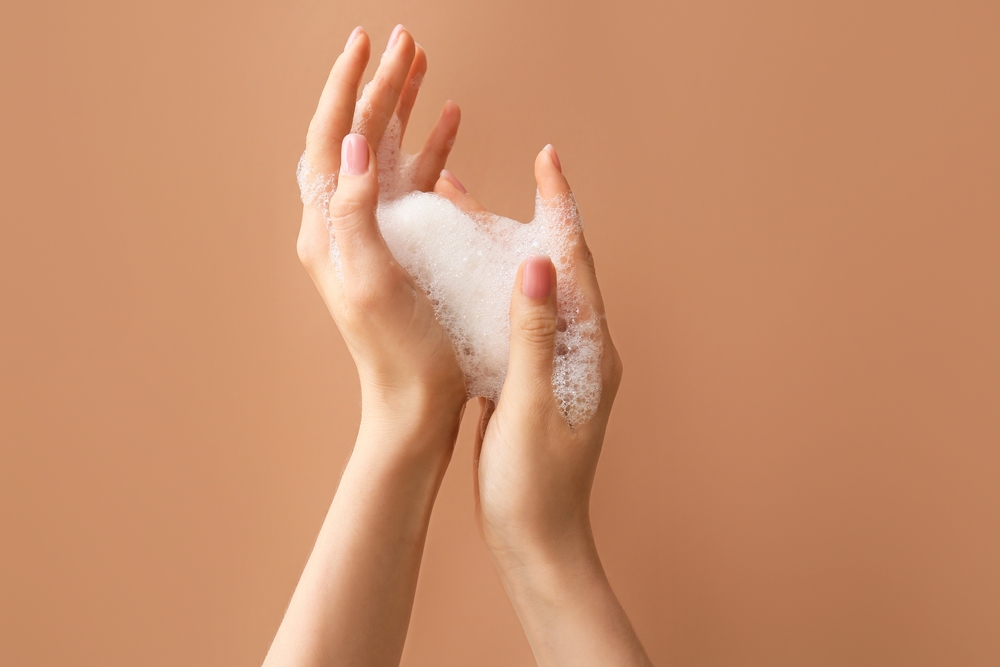 Woman,Washing,Hands,With,Soap,On,Color,Background